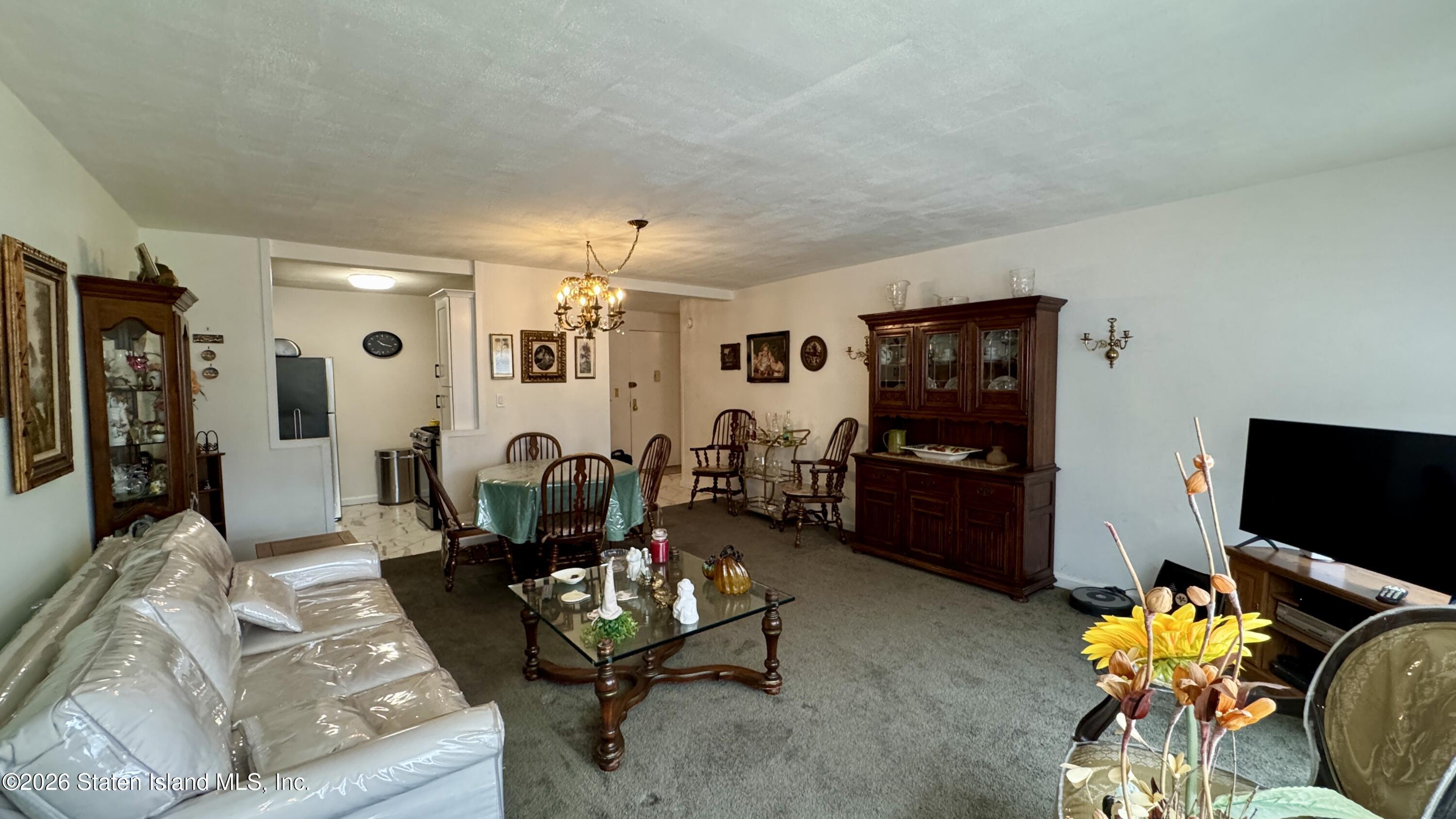 1100 Clove Road, Unit 2B Staten Island, NY 10301 - Photo 16 of 52 a living room with furniture and a flat screen tv