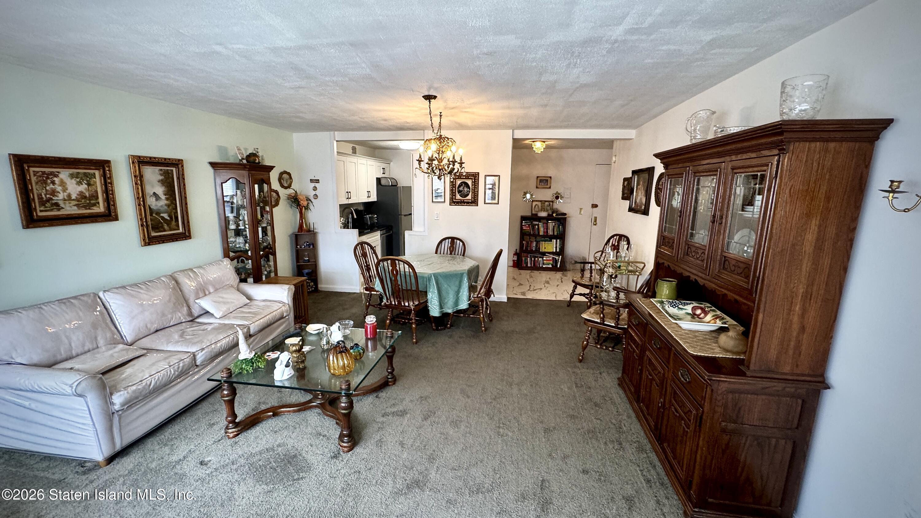 1100 Clove Road, Unit 2B Staten Island, NY 10301 - Photo 17 of 52 a living room with furniture a flat screen tv and a large window