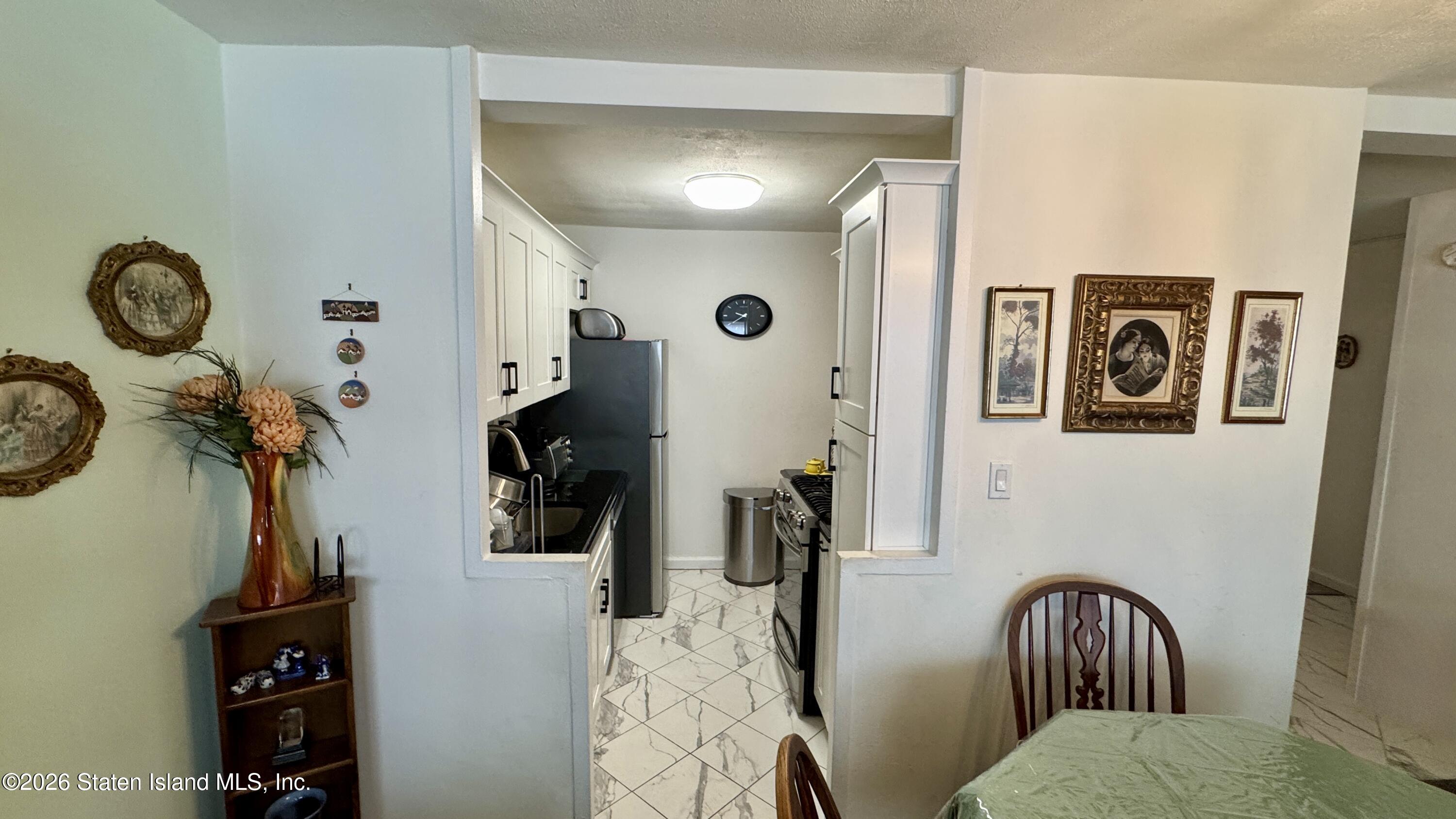 1100 Clove Road, Unit 2B Staten Island, NY 10301 - Photo 19 of 52 a view of walk in closet with clothes and shoes