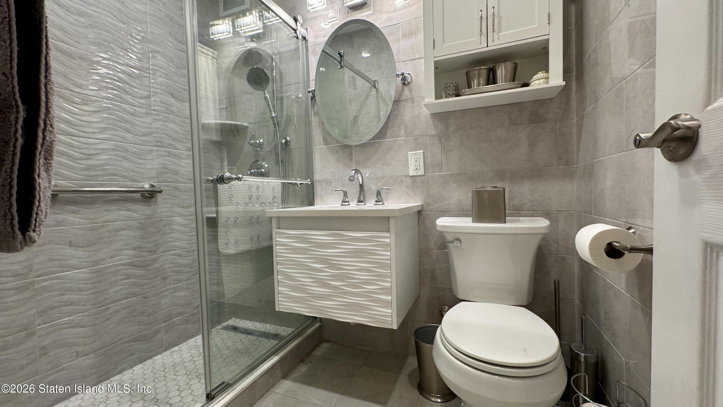 1100 Clove Road, Unit 2B Staten Island, NY 10301 - Photo 27 of 52 a bathroom with a toilet and a sink