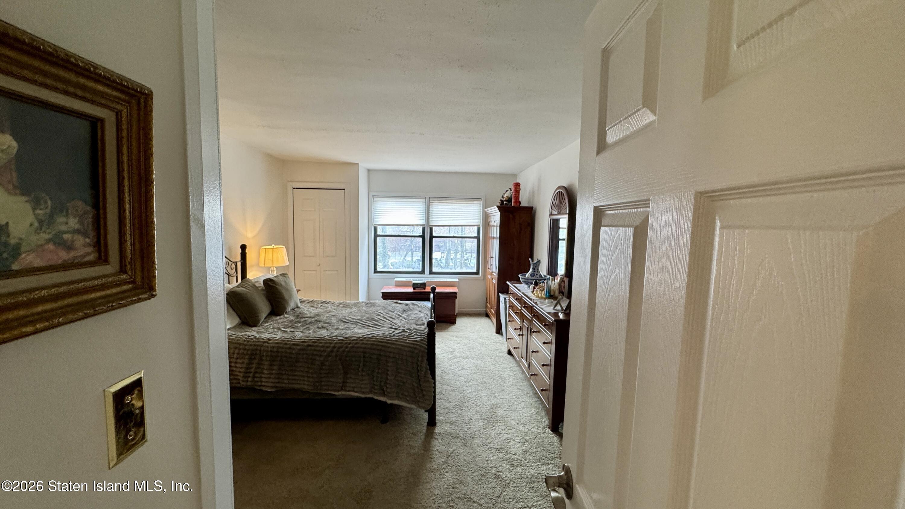 1100 Clove Road, Unit 2B Staten Island, NY 10301 - Photo 32 of 52 a bedroom with furniture and a window