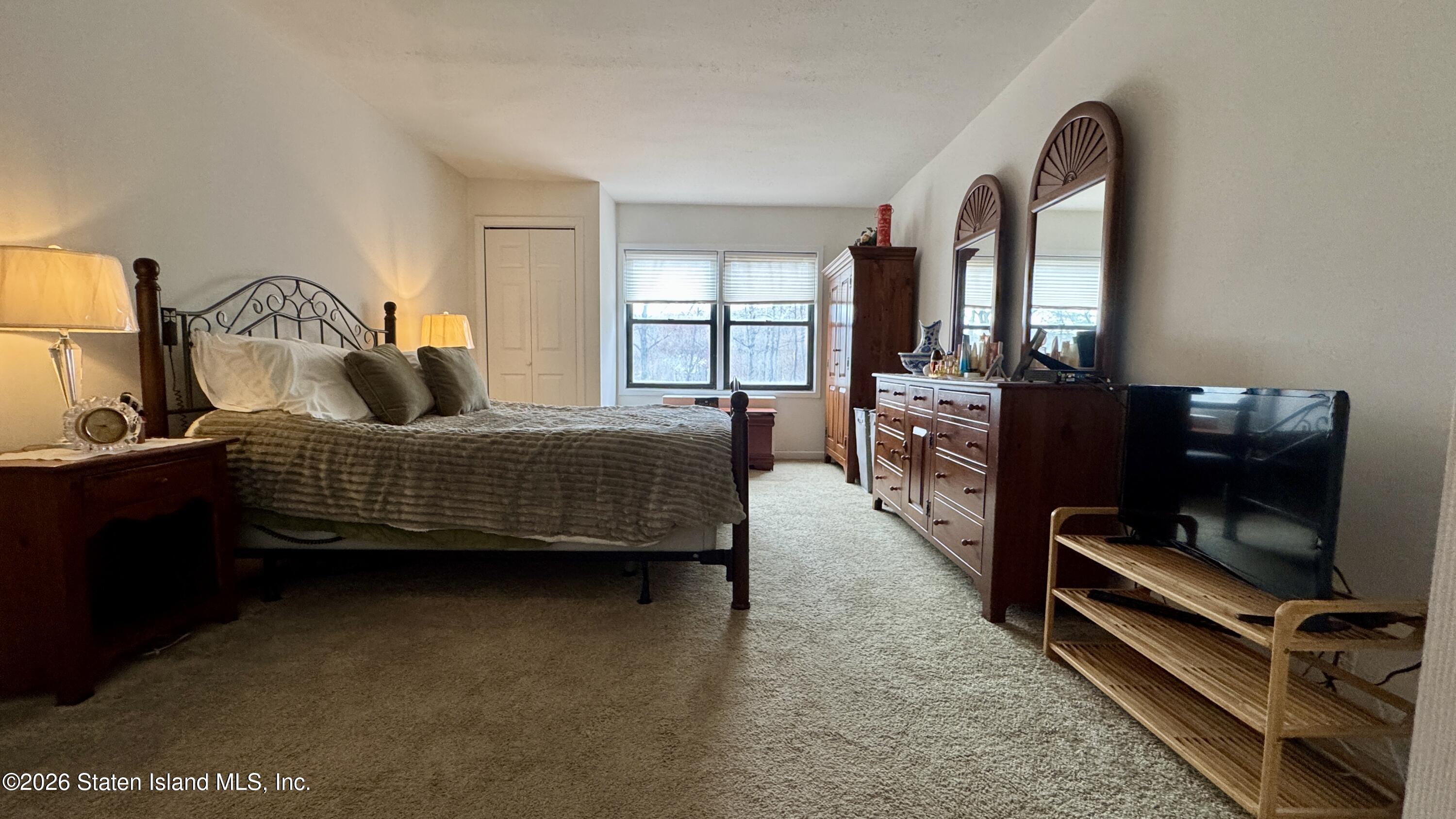 1100 Clove Road, Unit 2B Staten Island, NY 10301 - Photo 33 of 52 a bedroom with bed and a window