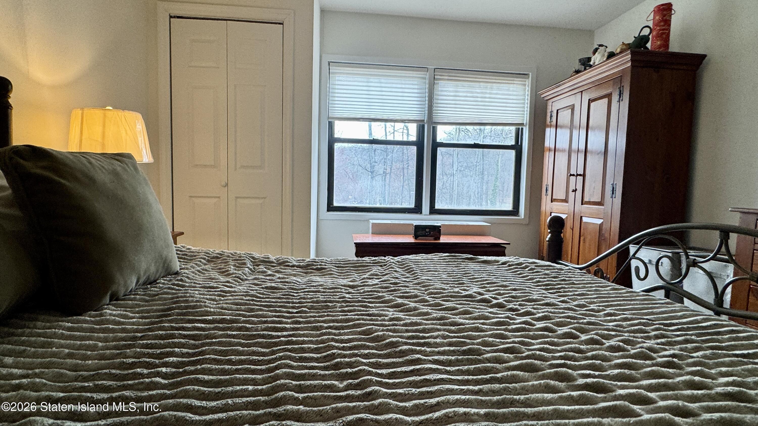 1100 Clove Road, Unit 2B Staten Island, NY 10301 - Photo 36 of 52 a bedroom with a bed and a window