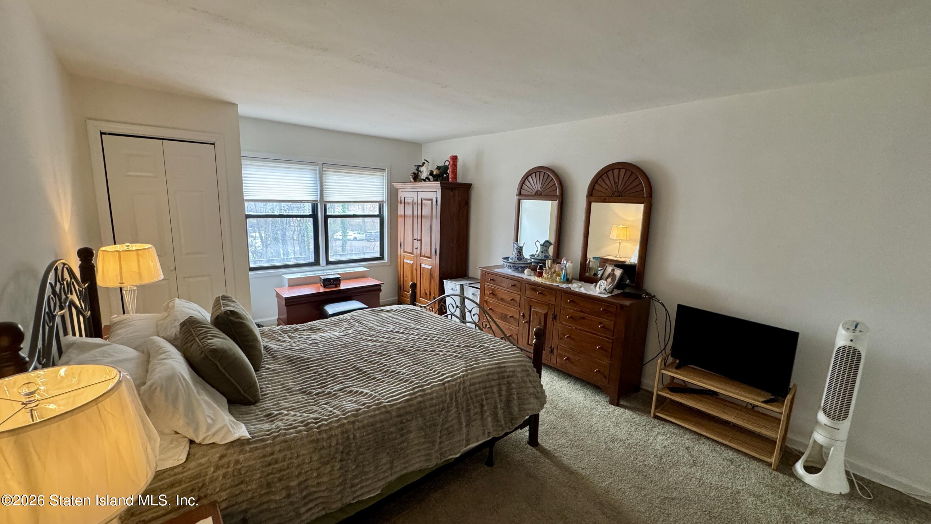 1100 Clove Road, Unit 2B Staten Island, NY 10301 - Photo 37 of 52 a bedroom with a bed and wooden floor