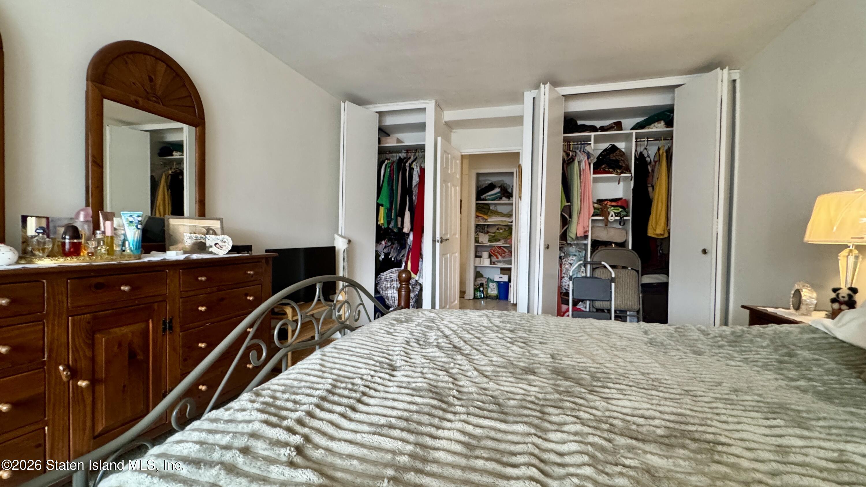 1100 Clove Road, Unit 2B Staten Island, NY 10301 - Photo 38 of 52 a bedroom with a bed and a dresser