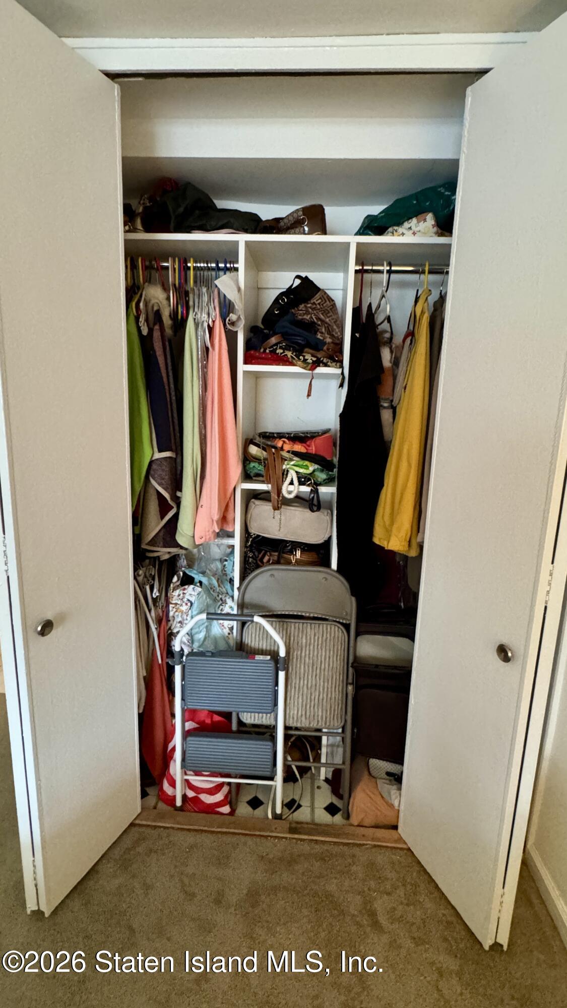 1100 Clove Road, Unit 2B Staten Island, NY 10301 - Photo 40 of 52 a view of walk in closet with clothes and shoes