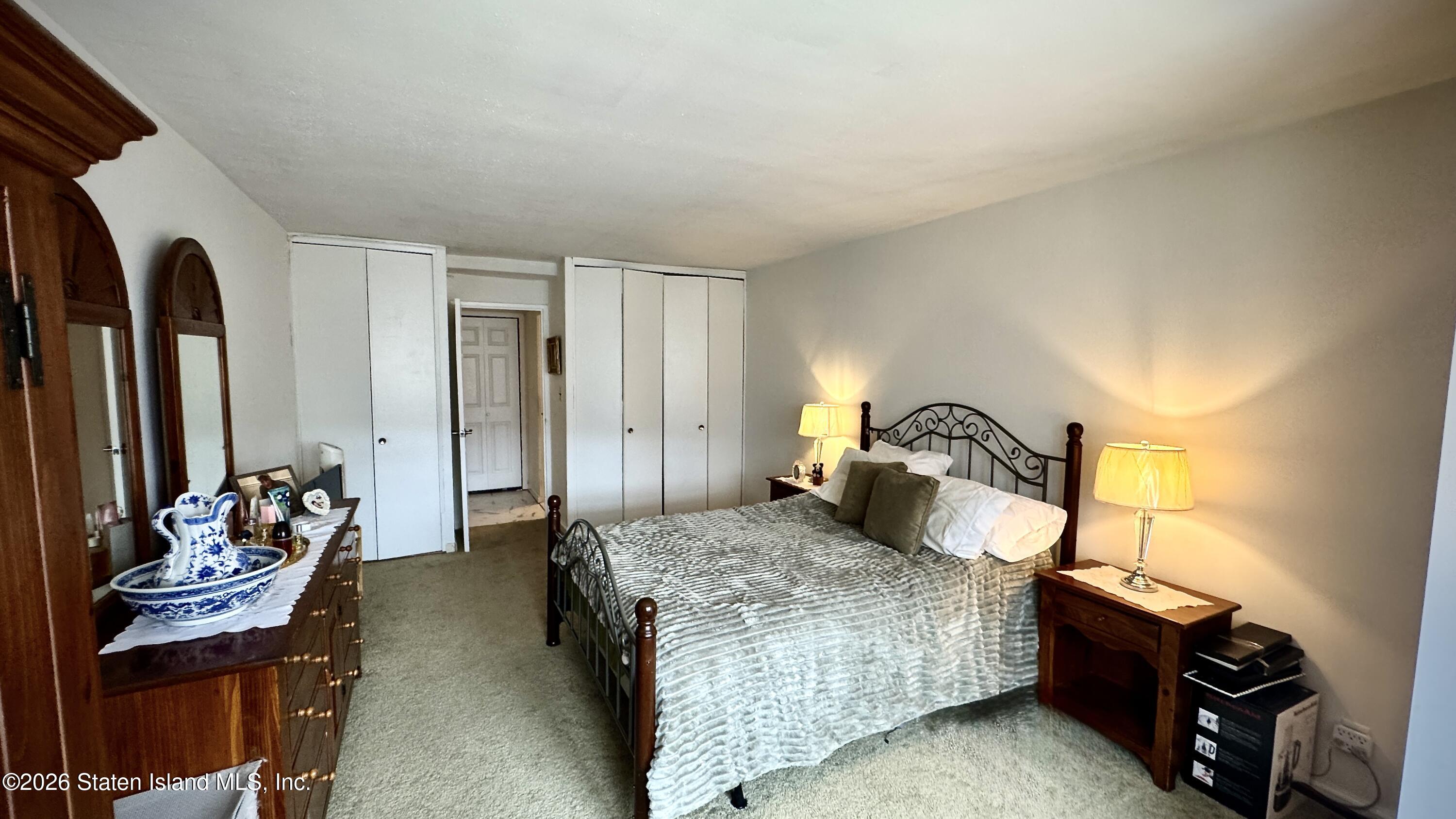 1100 Clove Road, Unit 2B Staten Island, NY 10301 - Photo 42 of 52 a bedroom with a bed and wooden floor