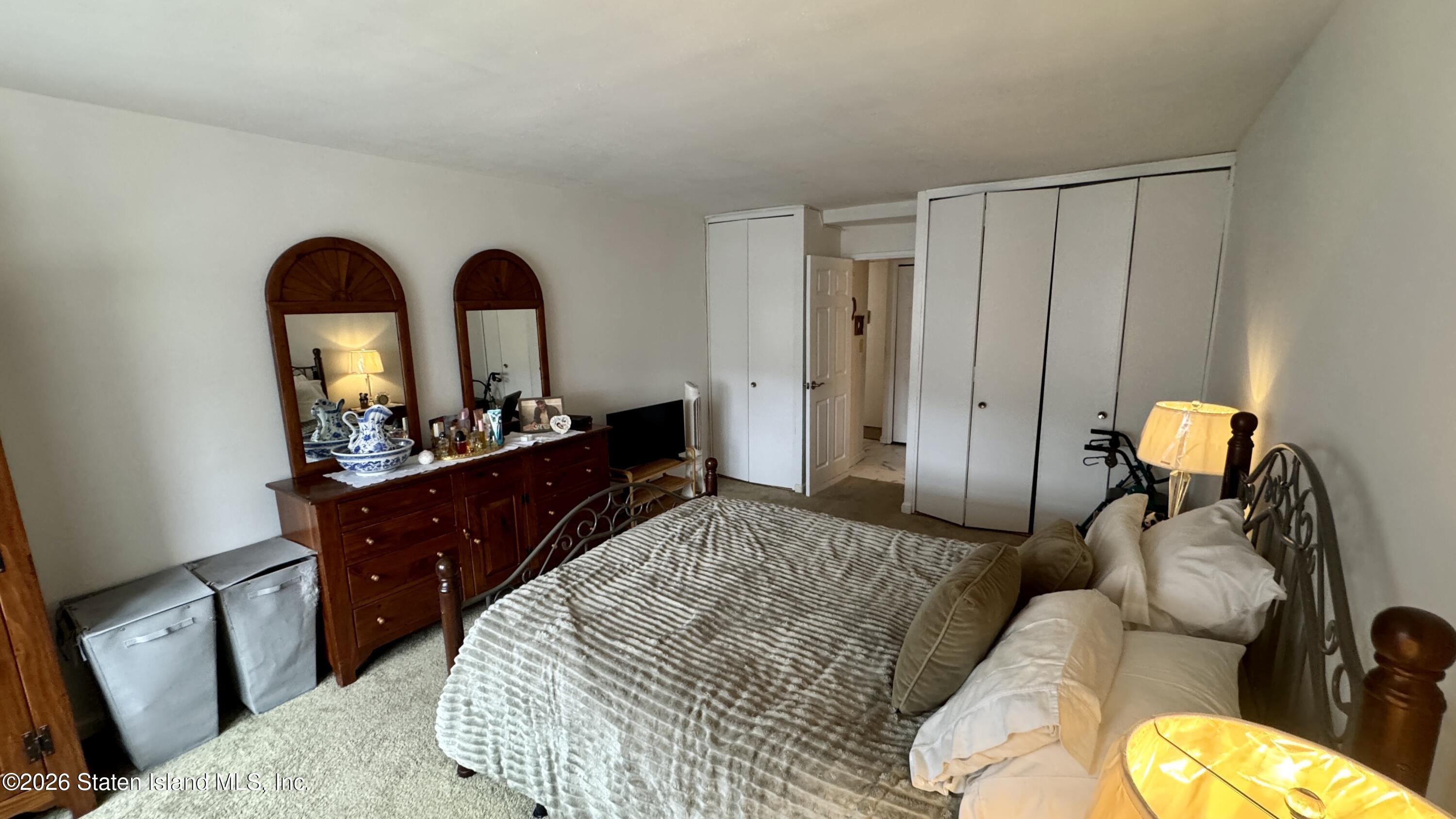 1100 Clove Road, Unit 2B Staten Island, NY 10301 - Photo 43 of 52 a bedroom with a bed and a dresser