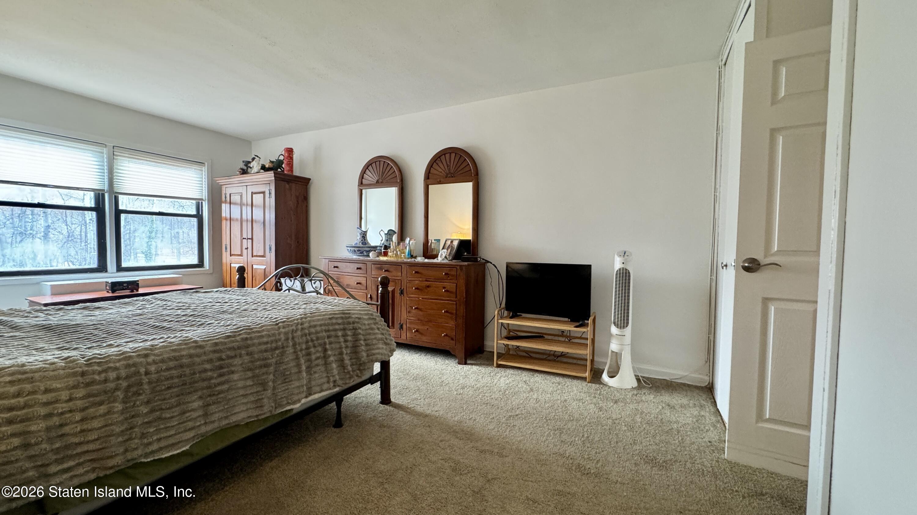 1100 Clove Road, Unit 2B Staten Island, NY 10301 - Photo 44 of 52 a bedroom with a bed and tv