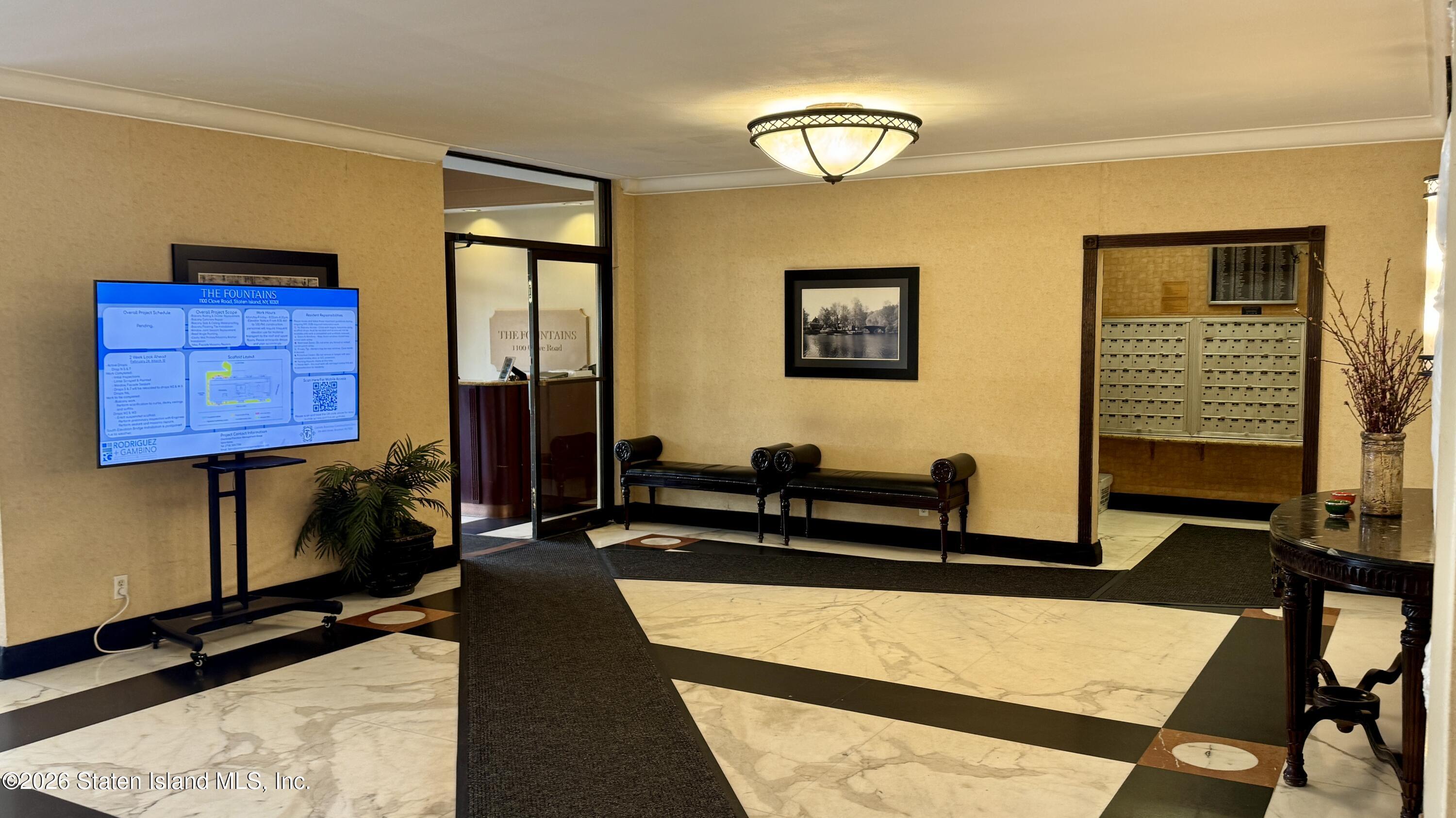 1100 Clove Road, Unit 2B Staten Island, NY 10301 - Photo 8 of 52 a living room with furniture gym equipment and a window
