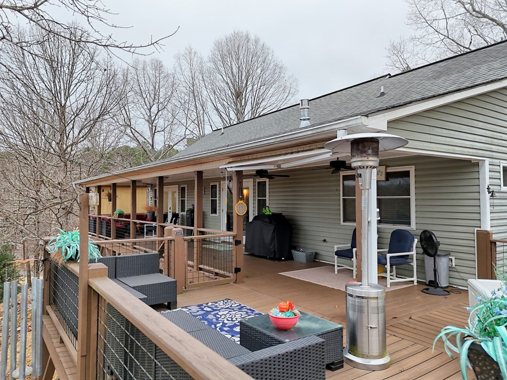 340 Country Mountain Ridge Drive Murphy, NC 28906 - Photo 13 of 73 a view of a patio with table and chairs barbeque potted plants and large tree