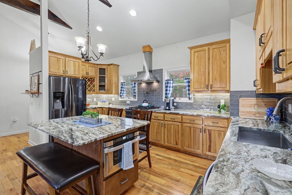 340 Country Mountain Ridge Drive Murphy, NC 28906 - Photo 33 of 73 a kitchen with stainless steel appliances granite countertop a stove a sink dishwasher and a refrigerator with wooden floor