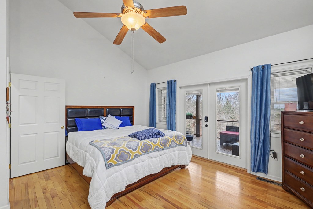 340 Country Mountain Ridge Drive Murphy, NC 28906 - Photo 40 of 73 a bedroom with a bed and a chandelier