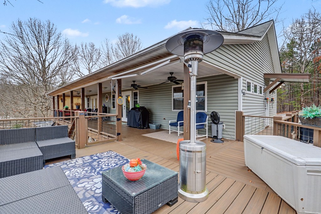 340 Country Mountain Ridge Drive Murphy, NC 28906 - Photo 46 of 73 a view of a patio with couches table and chairs with wooden floor and fence
