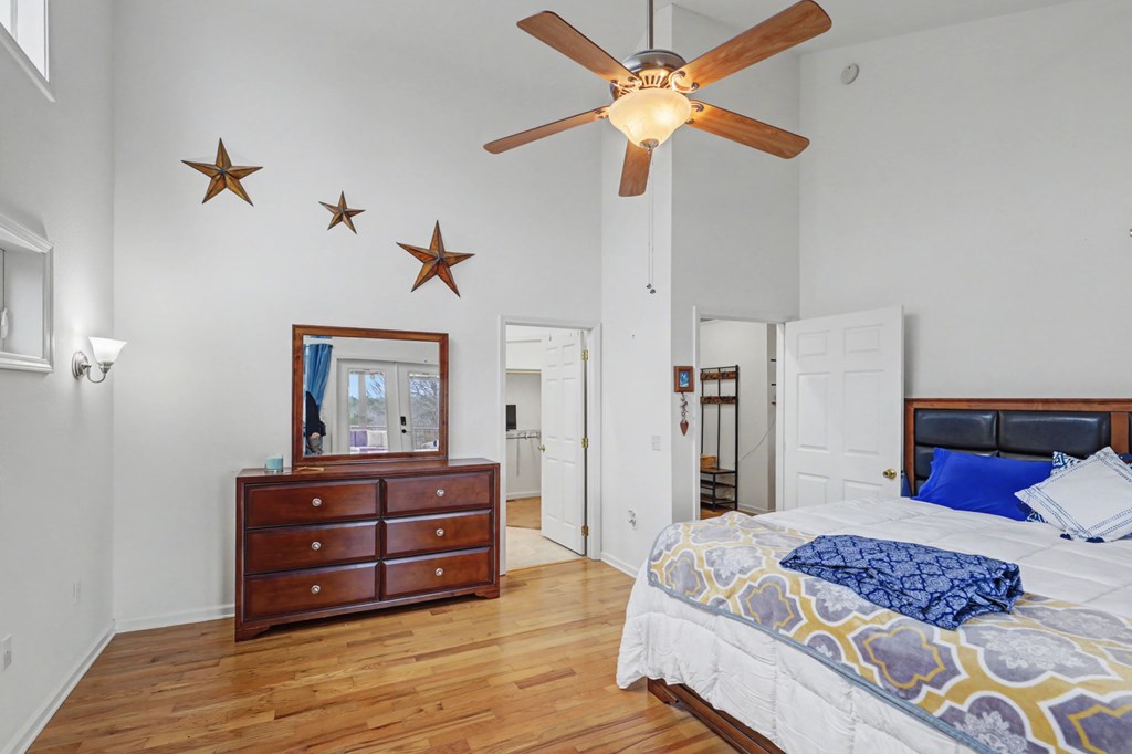 340 Country Mountain Ridge Drive Murphy, NC 28906 - Photo 49 of 73 a bedroom with a bed and a dresser with wooden floor