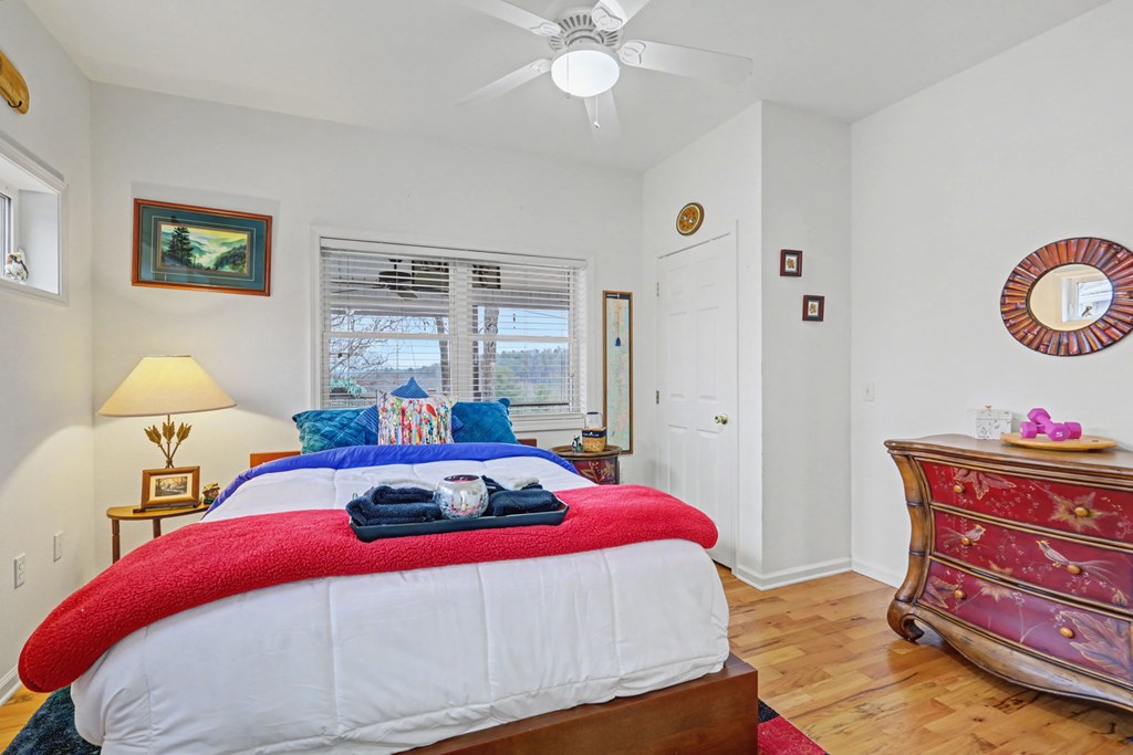 340 Country Mountain Ridge Drive Murphy, NC 28906 - Photo 58 of 73 a bedroom with a bed and a chandelier