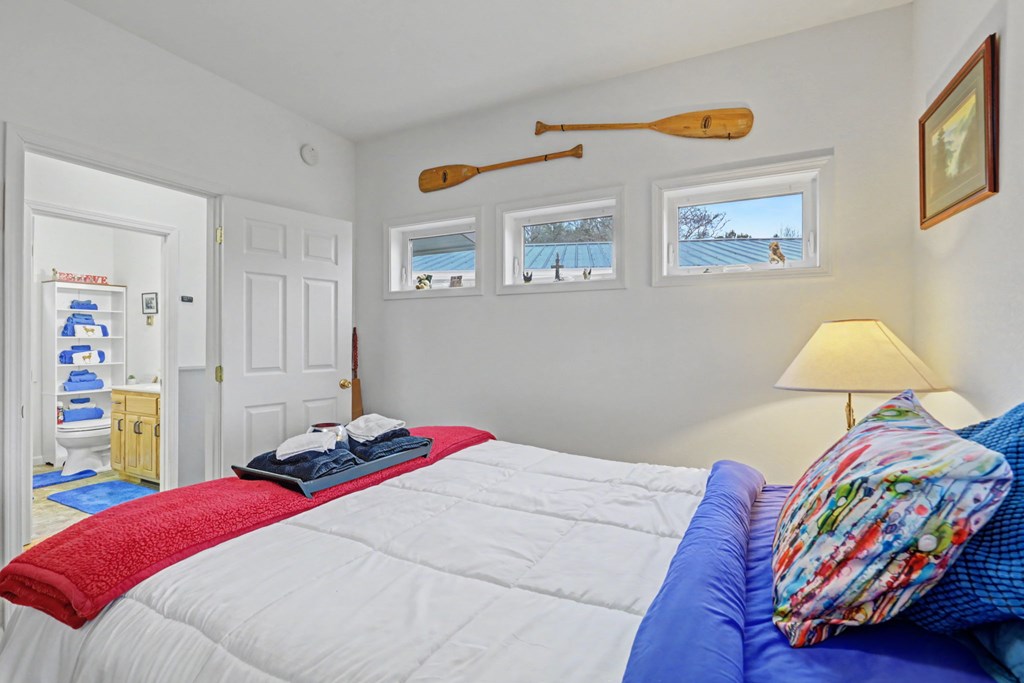 340 Country Mountain Ridge Drive Murphy, NC 28906 - Photo 59 of 73 a bedroom with a bed and a lamp