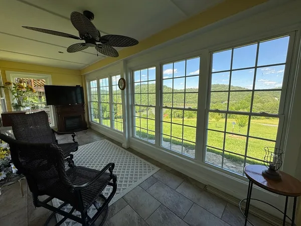 a living room with furniture and a floor to ceiling window