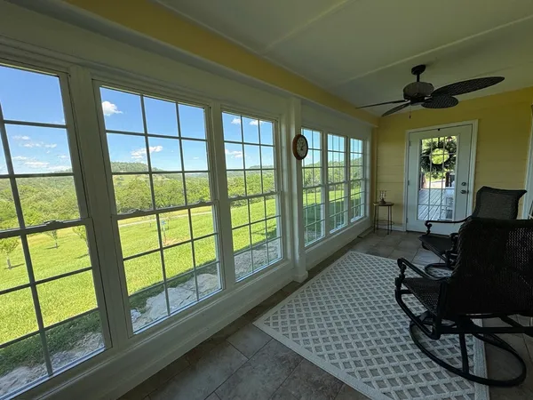 a dining room with furniture a chandelier and window
