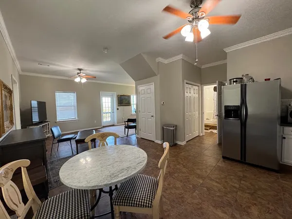 a living room with furniture and kitchen view