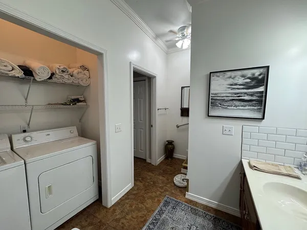 a bedroom with a bed and a ceiling fan