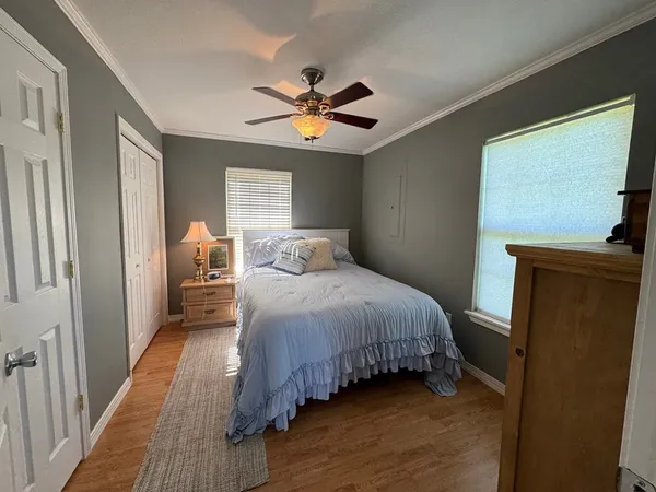 a living room with furniture a flat screen tv and a dining table
