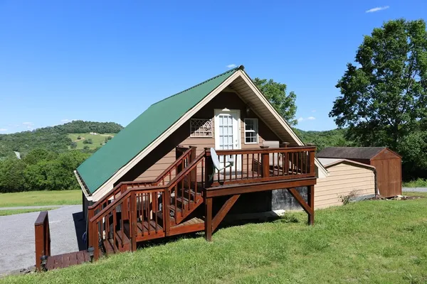 a open kitchen with stainless steel appliances granite countertop a refrigerator a stove a dining table and chairs with wooden floor