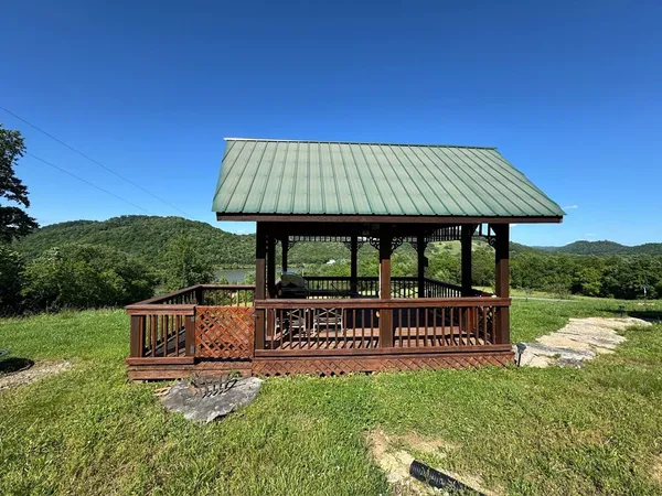 a view of a porch with furniture and a fireplace