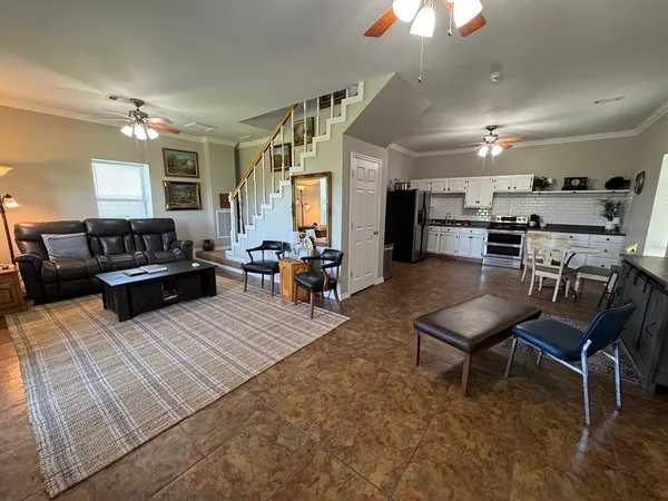 a living room with furniture fireplace and flat screen tv