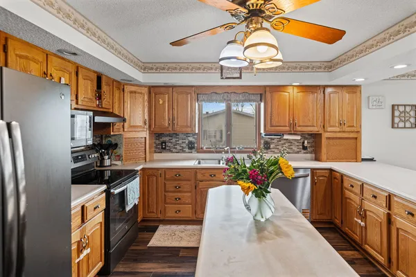 a kitchen with stainless steel appliances granite countertop a sink stove and refrigerator