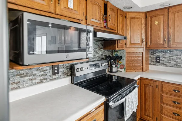 a kitchen with stainless steel appliances granite countertop a sink and a stove