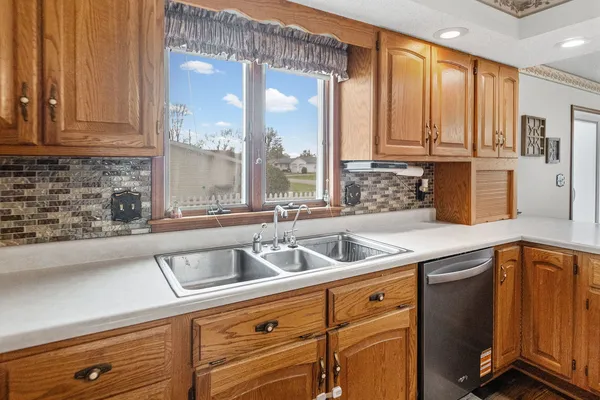 a kitchen with stainless steel appliances granite countertop a sink a stove and cabinets