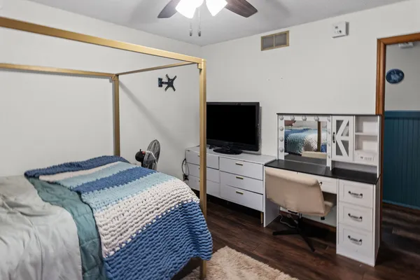 a bedroom with a bed and a chandelier