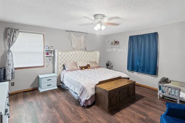 a bed room with a bed and a chair