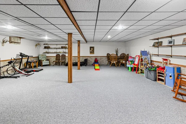 a view of a livingroom with furniture and a garage