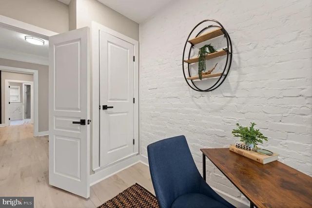 a view of a hallway with paintings on the wall