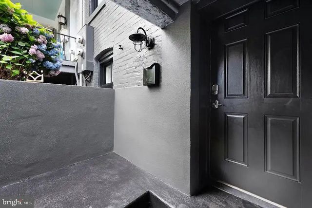 a living room with furniture and a painting on the wall