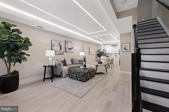 a living room with furniture and a potted plant
