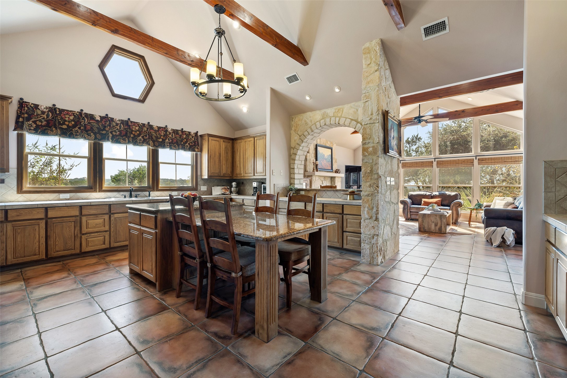 1120 Canyon View Road Dripping Springs, TX 78620 - Photo 11 of 40 a kitchen with lots of wooden cabinets appliances and furniture