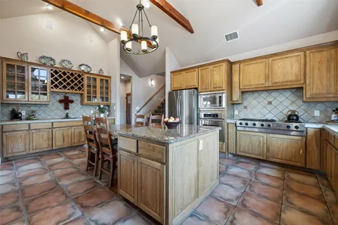 a view of kitchen with sink and refrigerator