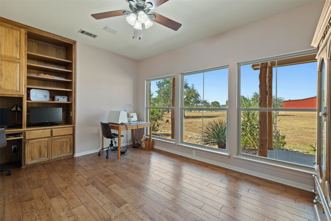 1120 Canyon View Road Dripping Springs, TX 78620 - Photo 19 of 40 a view of a livingroom with furniture window and wooden floor