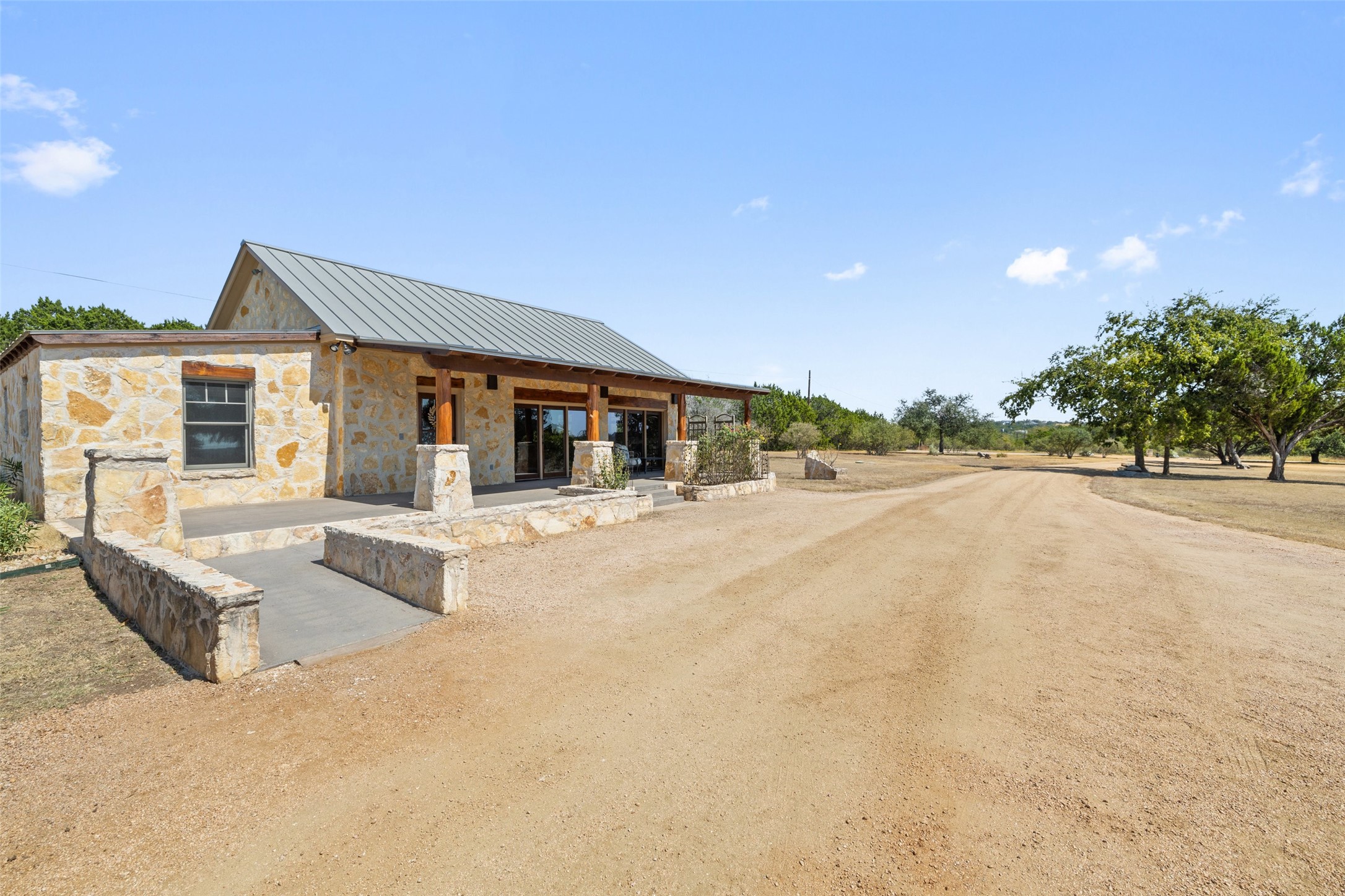 1120 Canyon View Road Dripping Springs, TX 78620 - Photo 26 of 40 a front view of house with yard and trees in the background