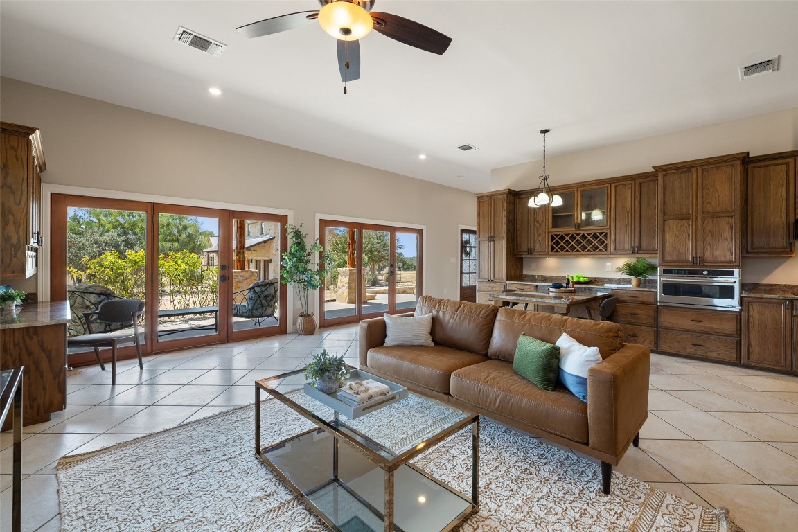 1120 Canyon View Road Dripping Springs, TX 78620 - Photo 40 of 40 a living room with furniture and a large window with kitchen view