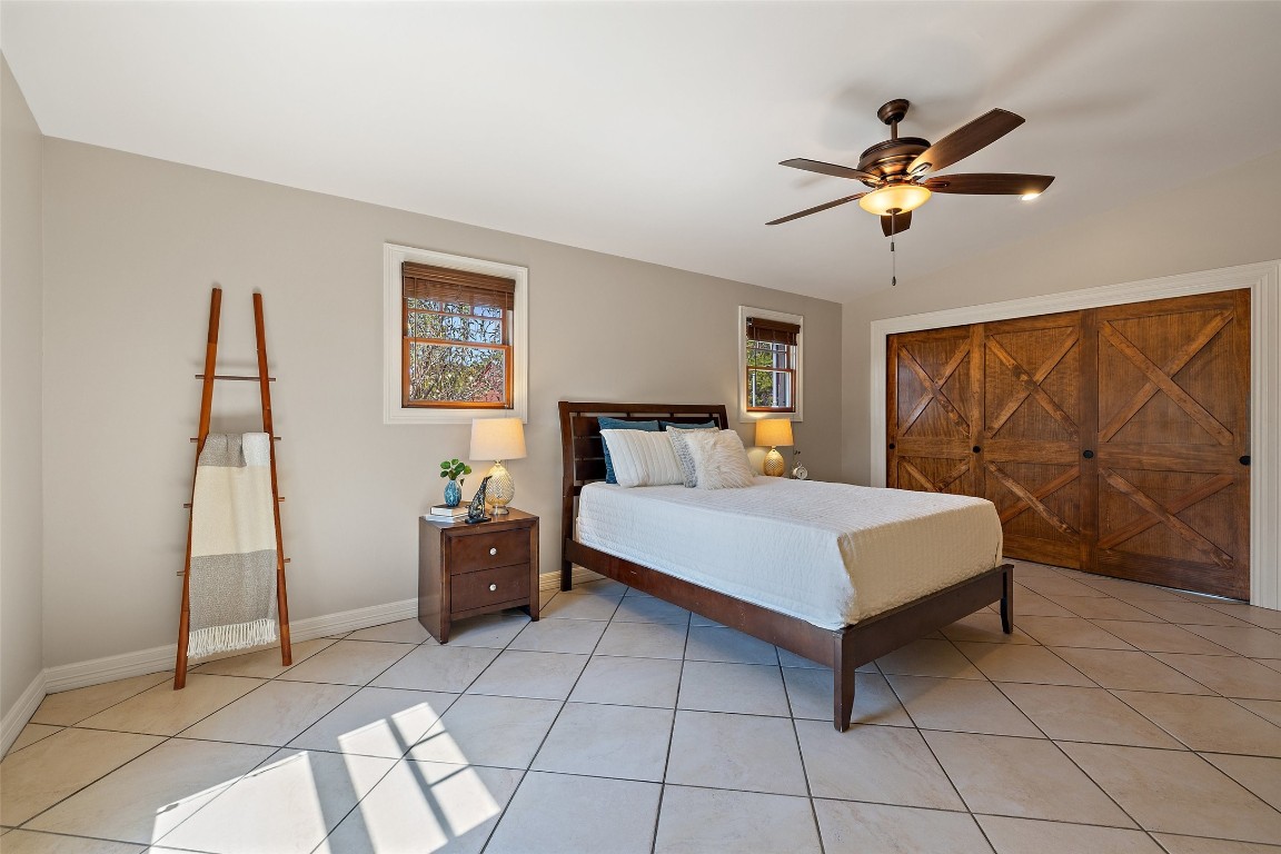 1120 Canyon View Road Dripping Springs, TX 78620 - Photo 29 of 40 a bedroom with a bed and window