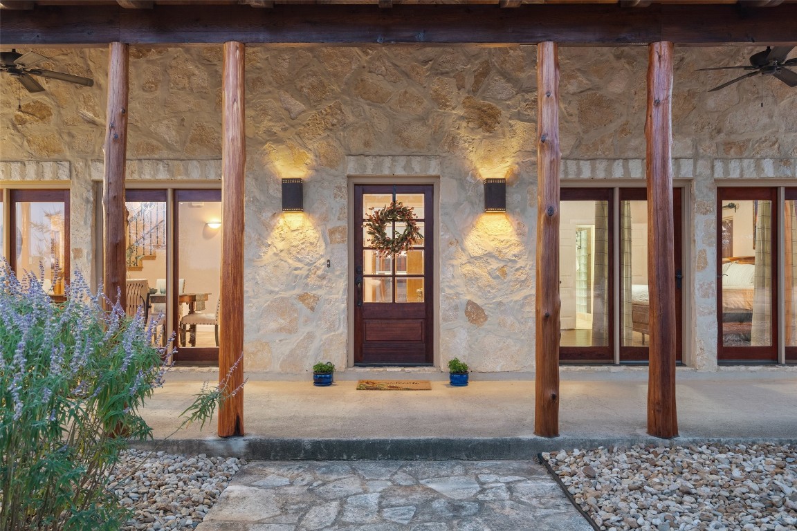 1120 Canyon View Road Dripping Springs, TX 78620 - Photo 3 of 40 a front view of a building with a potted plant