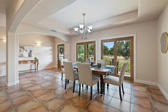 a living room with furniture a flat screen tv and a floor to ceiling window