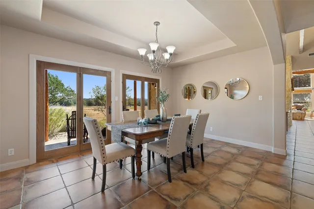 a living room with furniture a fireplace and a floor to ceiling window