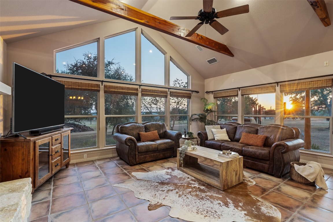 1120 Canyon View Road Dripping Springs, TX 78620 - Photo 8 of 40 a living room with furniture a flat screen tv and a floor to ceiling window
