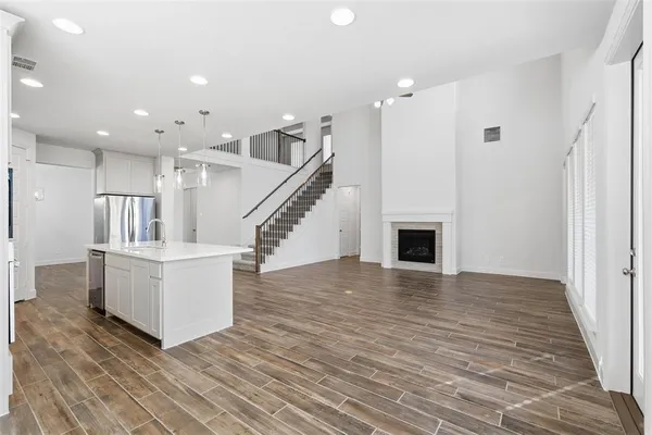 a view of kitchen and hall with wooden floor