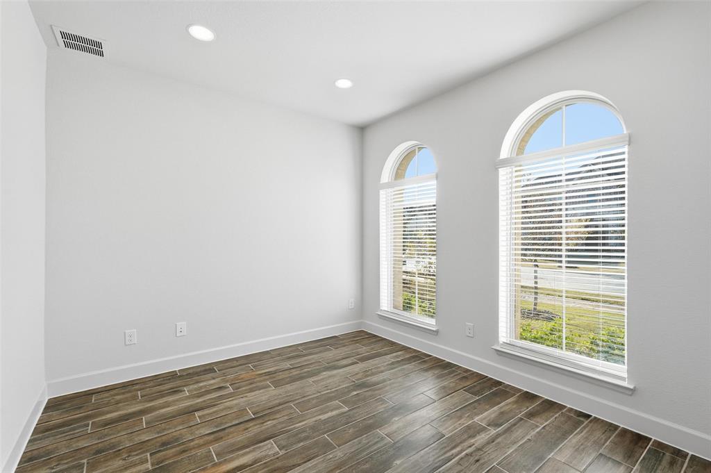 3329 Lacebark Lane Celina, TX 75009 - Photo 12 of 35 an empty room with wooden floor and windows